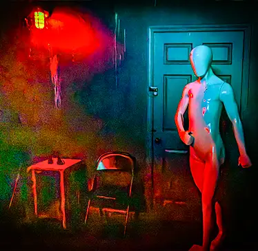 Nude mannequin bathed in red and blue light standing near a door, with a small table and chair in a dark, moody room. | Escape Code | Branson, Missouri Escape Room