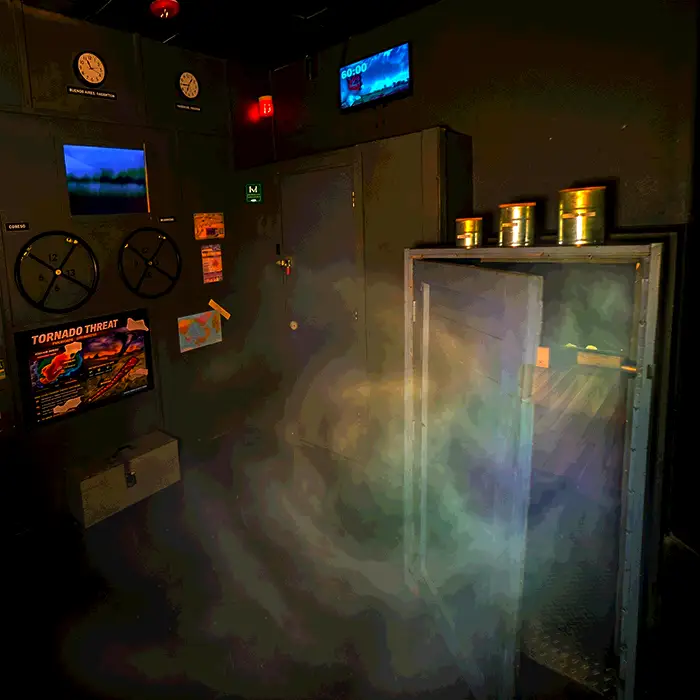 Dim control-room scene with gauges, warning signs, and a foggy display simulating a tornado threat scenario. | Escape Code | Branson, Missouri Escape Room